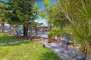 Relax by the pool surrounded by lush trees and a serene atmosphere.