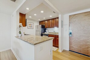 Enjoy cooking in this well-equipped kitchen with a granite countertop island, oven, and dishwasher.