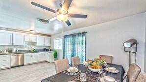 A modern kitchen with white cabinets, a stainless steel dishwasher, and a ceiling fan. - VIP villa 3BDR 2BHR 5min to the strip large pool (Las Vegas)
