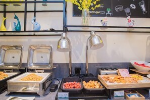 A buffet with various food items, including fruits, pastries, and a bowl of watermelon. - City Comfort Inn Hotel (Tian'e Bus Terminal) (Tian'e)