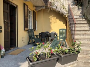 Relax in a charming outdoor space with a stone staircase and comfortable seating.