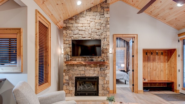 A cozy living room with a stone fireplace, a flat-screen TV, and a comfortable seating area. - Banner Bear - 1 mile from downtown Banner Elk, Skiing, restaurants (Banner Elk)