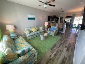 A living room with patterned sofas, a green rug, and a ceiling fan. - BETTER THAN HOTEL! 2 Suites!! (Sneads Ferry)