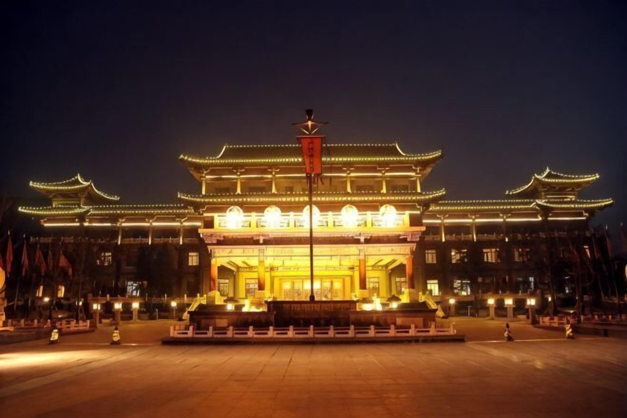 A traditional building with a prominent entrance and a flagpole.