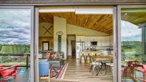 A modern interior with a wooden ceiling, a kitchen, and a dining area.