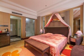 A bedroom with a canopy bed, a bench, a nightstand, and a mirror.
