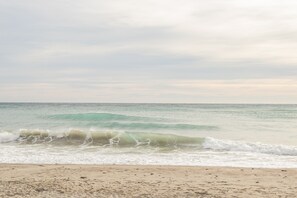 A beach with waves approaching the shore.
