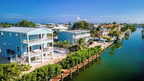 A waterfront property with multiple buildings, a dock, and a marina.