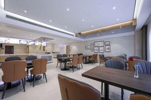 Un restaurante moderno con barra, mesas y sillas.