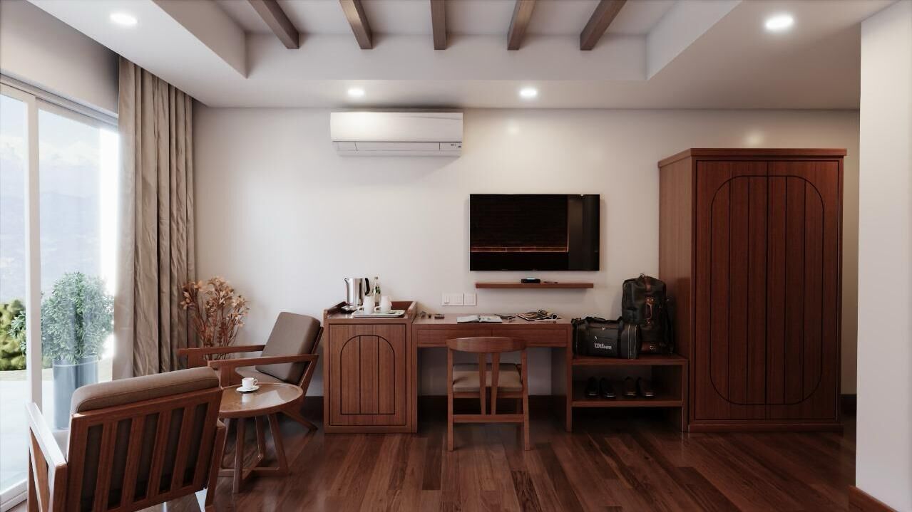 A modern room with a wooden desk, a TV mounted on the wall, a wardrobe, and a large window with curtains.