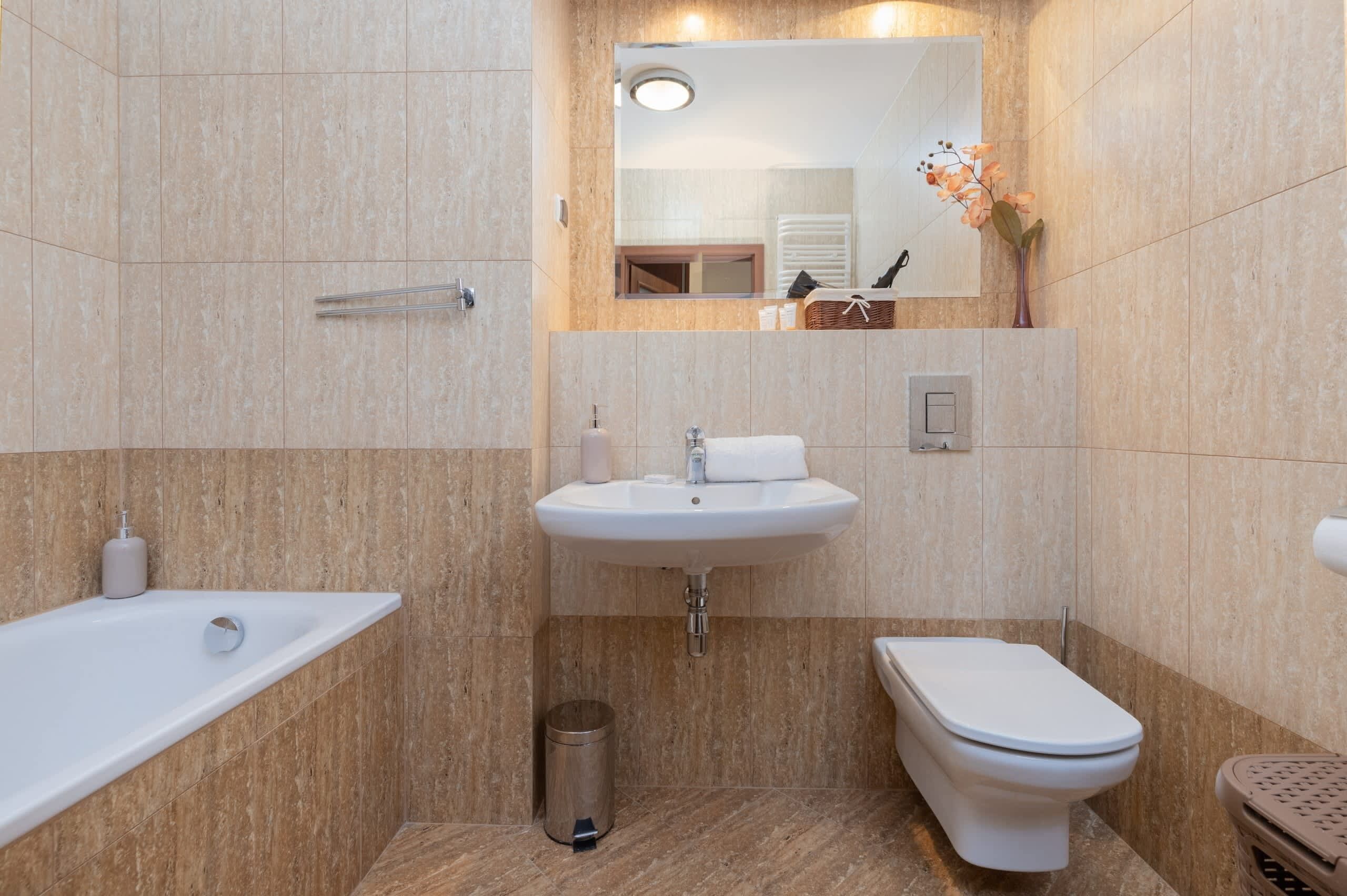 A modern bathroom with a bathtub, sink, and toilet.