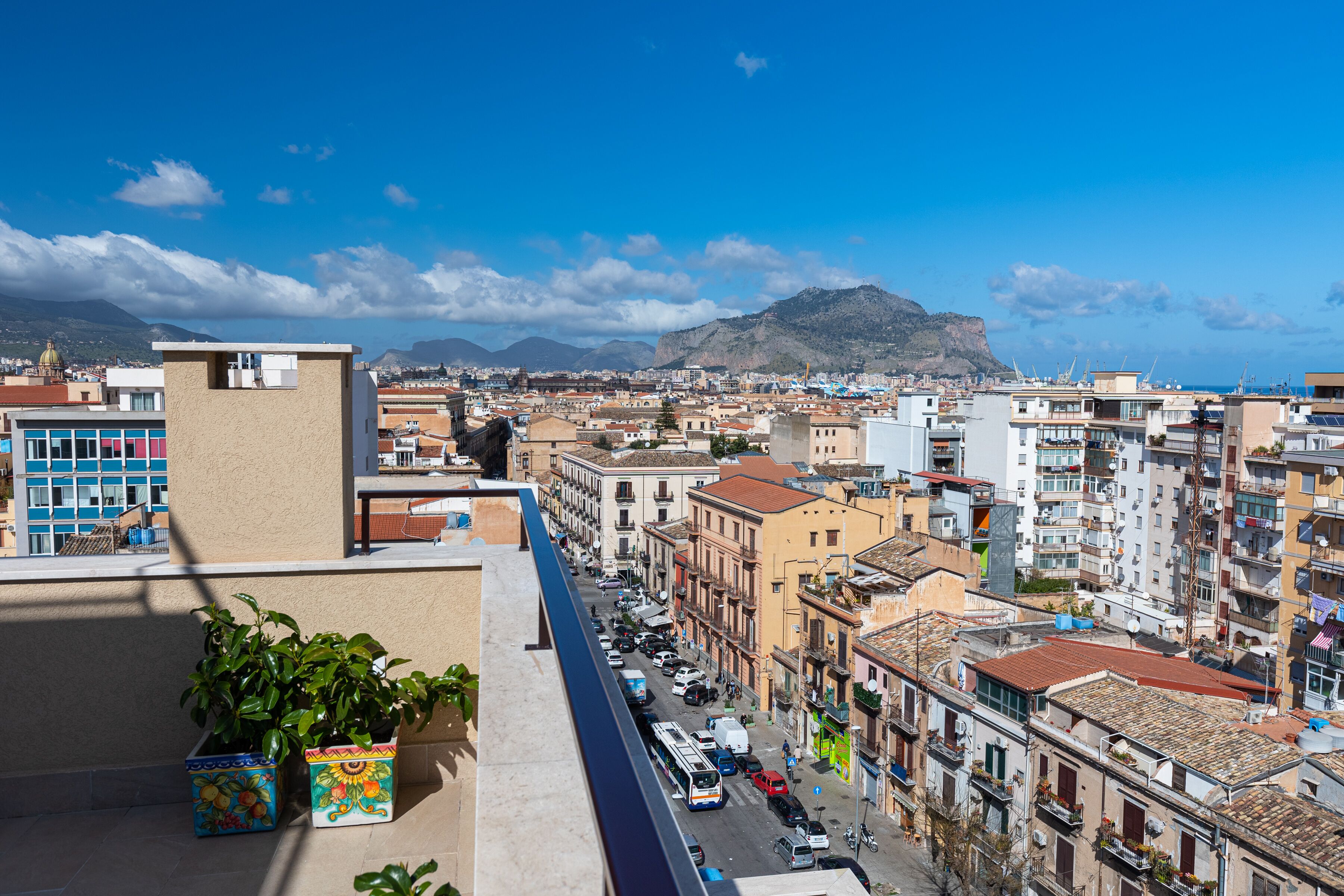 A cityscape with buildings, a street, and a mountain in the background.