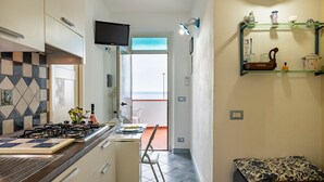 Coffee/tea maker, fridge, cookware/dishes/utensils, dining table - Casa Sisine (Cala Gonone)