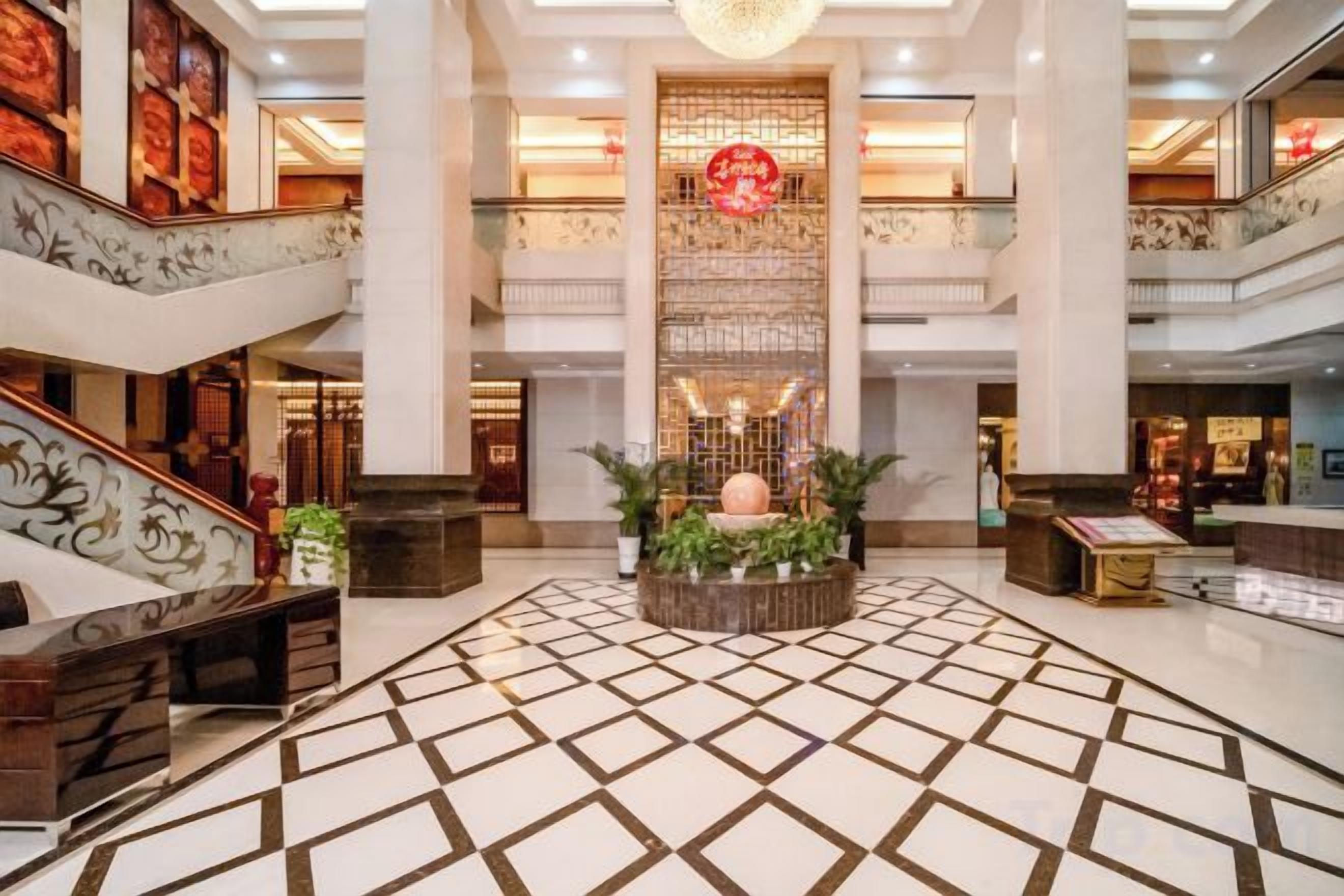 A spacious lobby with a central fountain, multiple floors, and a modern design.