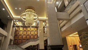 A grand lobby with a large chandelier, a marble staircase, and a high ceiling. - Jinxin Hotel (Xiangyuan)