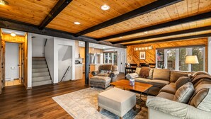 A spacious living room with a wooden ceiling, a sofa set, a coffee table, and a rug. - Winterset 3 3 Bedroom Condo by RedAwning (Steamboat Springs)