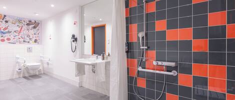 A modern bathroom with a toilet, sink, and shower.