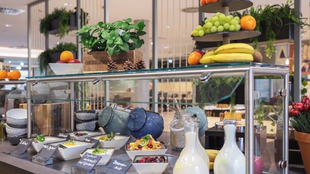 A buffet with various food items and a fruit display. - Holiday Inn - the niu, Amity Potsdam by IHG (Potsdam)