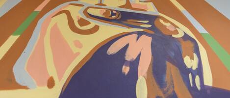 A close-up of a colorful abstract painting with bold lines and shapes.