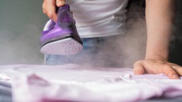 A person ironing a garment.