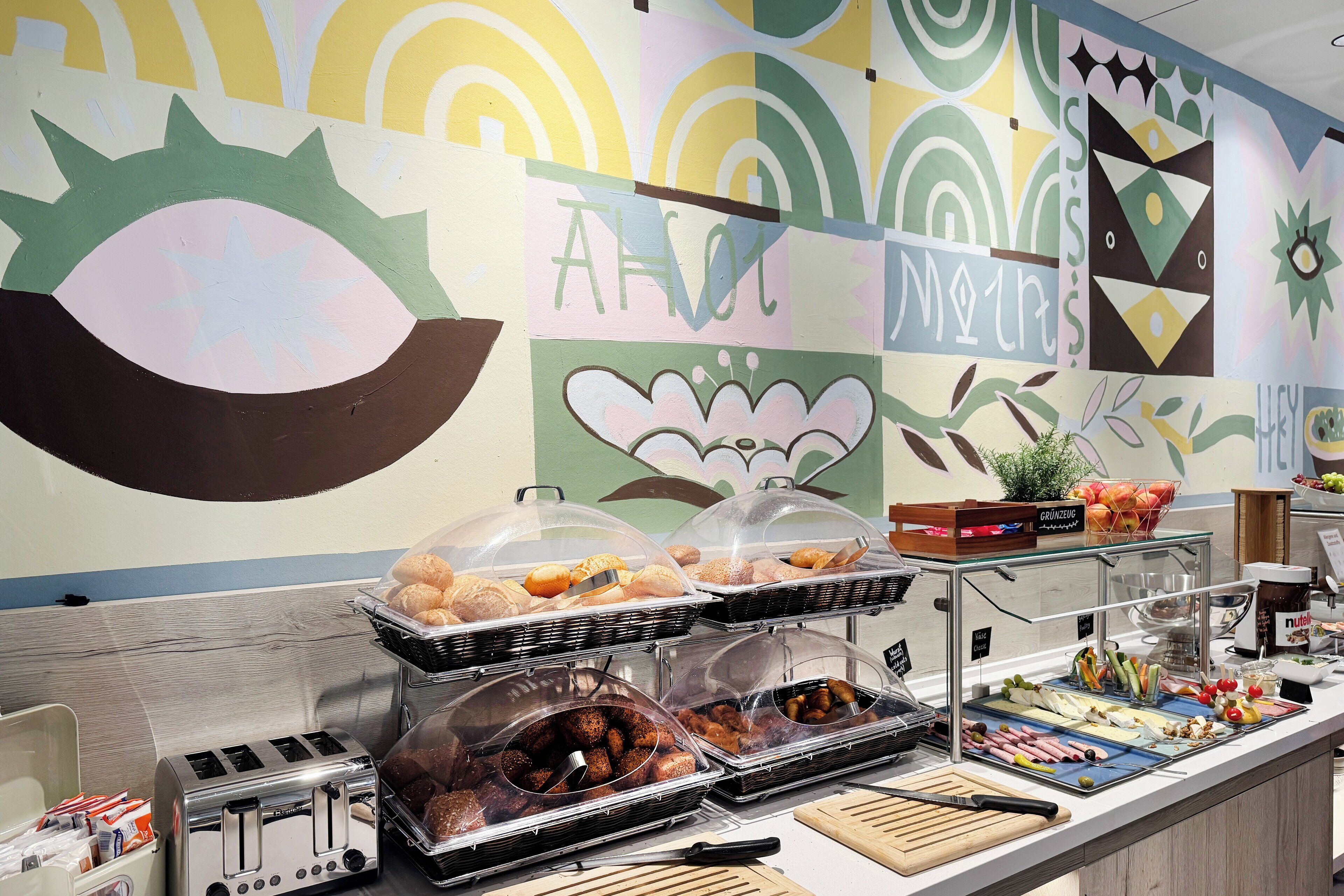 A buffet area with various food items and a toaster.