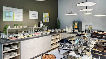 A buffet area with various food options, including a section for sandwiches, bowls, and an adventure category.