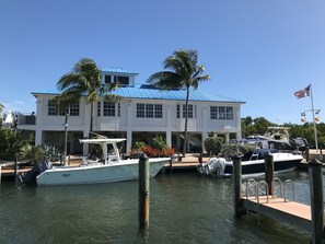 Enjoy waterfront views and access to a dock with a moored boat.