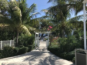 Stroll through lush tropical gardens to a beautifully maintained entrance.