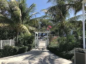 Stroll through lush tropical gardens to a beautifully maintained entrance.