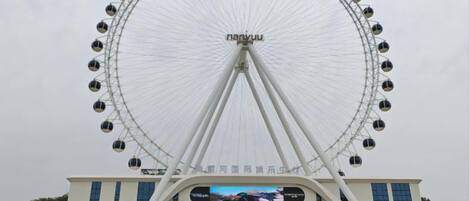 A large Ferris wheel with the name 'NANYU' at its base.