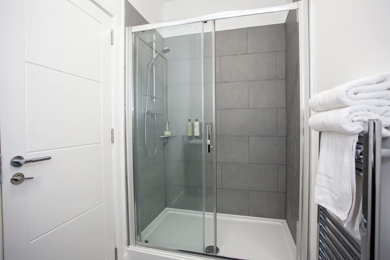 Shower, hair dryer, towels, shampoo