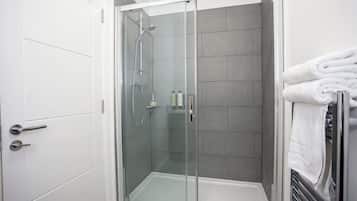 Shower, hair dryer, towels, shampoo