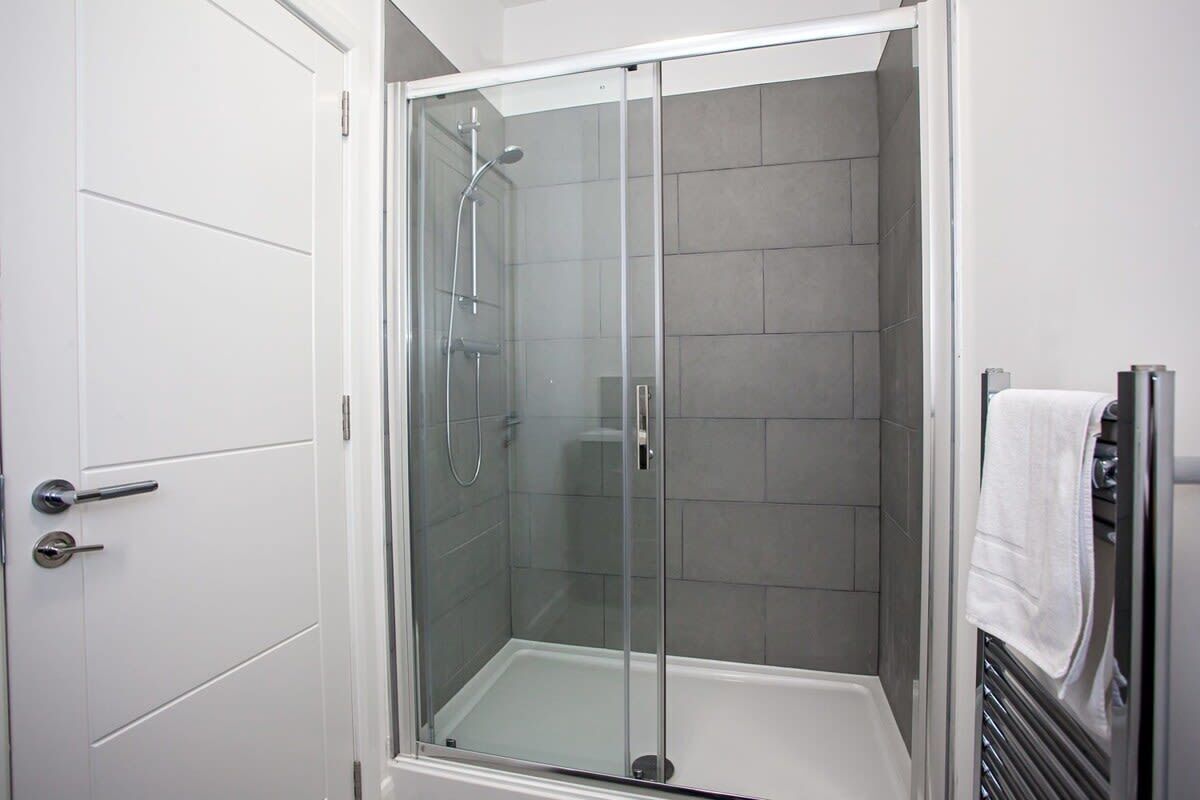 Shower, hair dryer, towels, shampoo