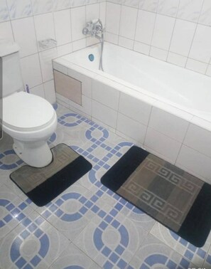 House, Multiple Beds | Bathroom | Combined shower/bathtub, deep-soaking bathtub, towels, shampoo - Captivating 4-bed House in Kampala (Kampala)