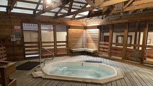 A wooden cabin with a hot tub, wooden floors, and a sloped ceiling. - Newly renovated 4BR & 3BR condo walk to slopes (Snowshoe)