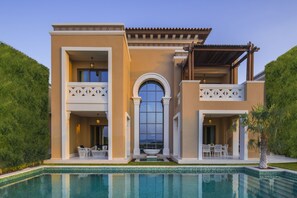 A two-story house with a swimming pool, outdoor seating, and a large arched window. - Club Privé by Rixos Saadiyat Island (Abu Dhabi)
