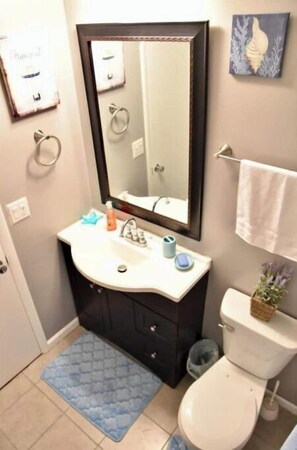 Combined shower/bathtub, towels, soap, toilet paper