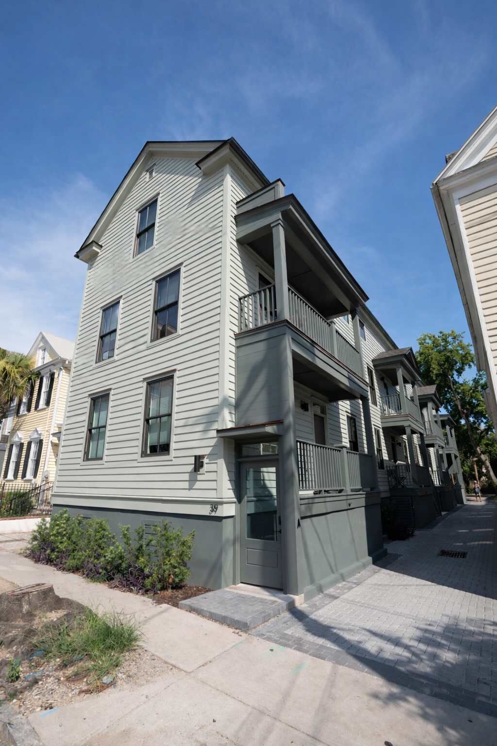 A two-story residential building with a balcony on the second floor.