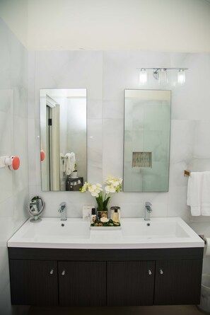 A modern bathroom with a large mirror, two sinks, and a dark wooden cabinet. - Modern Villa with private backyard pool (Drax hall)