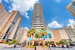 A high-rise hotel with a modern design, featuring a central reception area and multiple balconies. - Regency Luxury Suites (Dubai)
