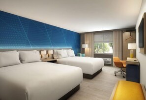 A hotel room with two beds, a desk, a chair, a TV, and a window with curtains.