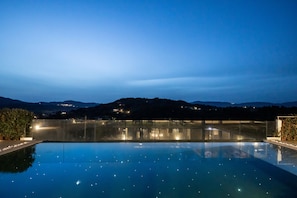 Outdoor pool, a heated pool, pool umbrellas, pool loungers