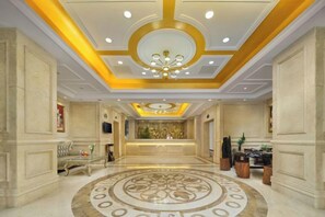 A hotel lobby with a reception desk, a chandelier, and a patterned floor. - Vienna 3 Best Hotel (Yangchun Bus Station) (Yangchun)