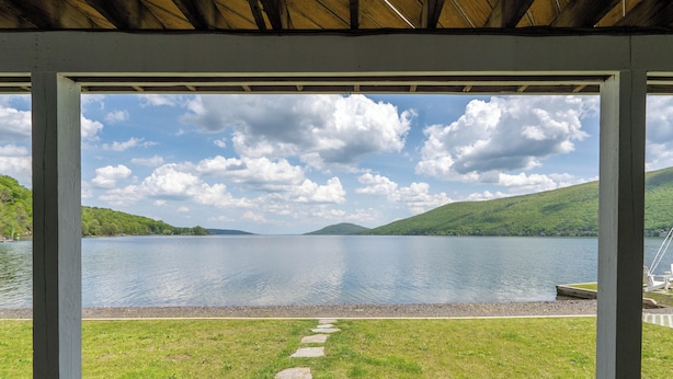 A covered outdoor area with a stone path leading to a lake view. - The Chosen Spot: Secluded, Views, Wineries, Hot tub, Skiing, Pet friendly! (Naples)