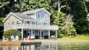 A two-story house with a balcony, a dock, and a small boat. - The Chosen Spot: Secluded, Views, Wineries, Hot tub, Skiing, Pet friendly! (Naples)