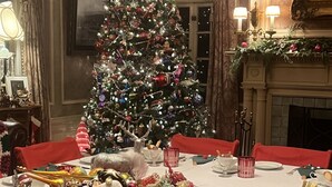 A Christmas tree in a dining area with a fireplace, red tablecloth, and festive decorations. - Pendleton House Historic Inn and B&B (Pendleton)