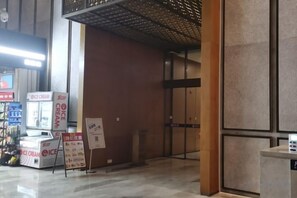 An indoor area with vending machines, a signboard, and a door. - Kaluowei Apartment (Zheshang Building) (Dongguan)