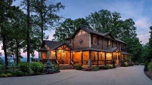 A two-story log cabin with a porch, surrounded by trees and a driveway. - The VUE Over Blue Ridge - Blue Ridge (Blue Ridge)