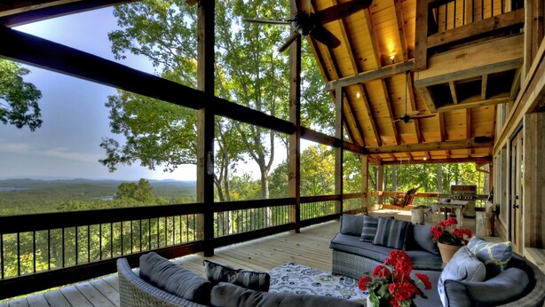 A covered outdoor seating area with wicker furniture and potted plants, overlooking a scenic landscape. - The VUE Over Blue Ridge - Blue Ridge (Blue Ridge)