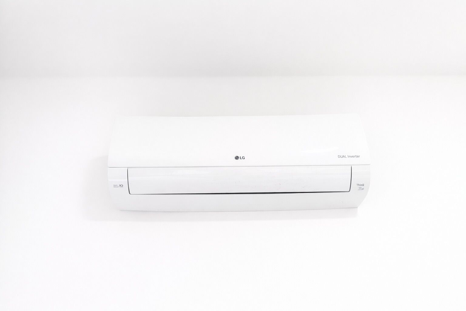 A white LG dual inverter air conditioner.